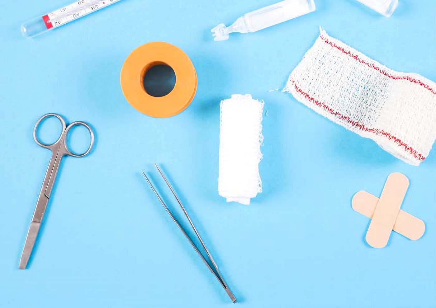 Medical supplies laid out on a blue surface